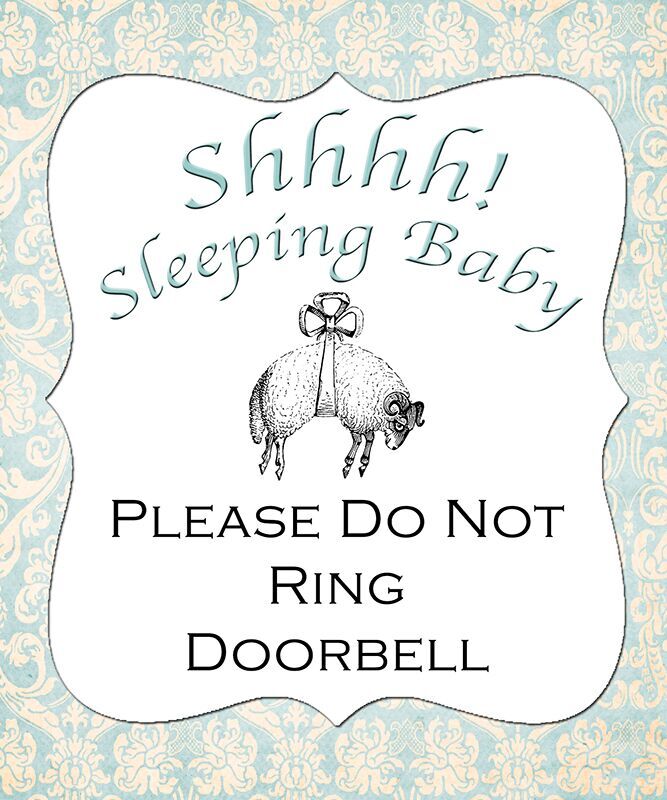 Pancarte DIY bébé dort accrochée à une porte