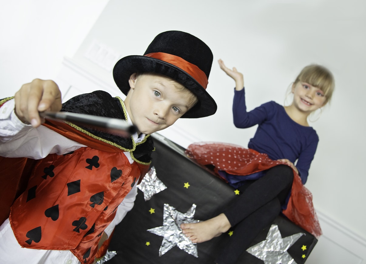 Enfants faisant un spectacle de magie dans le salon